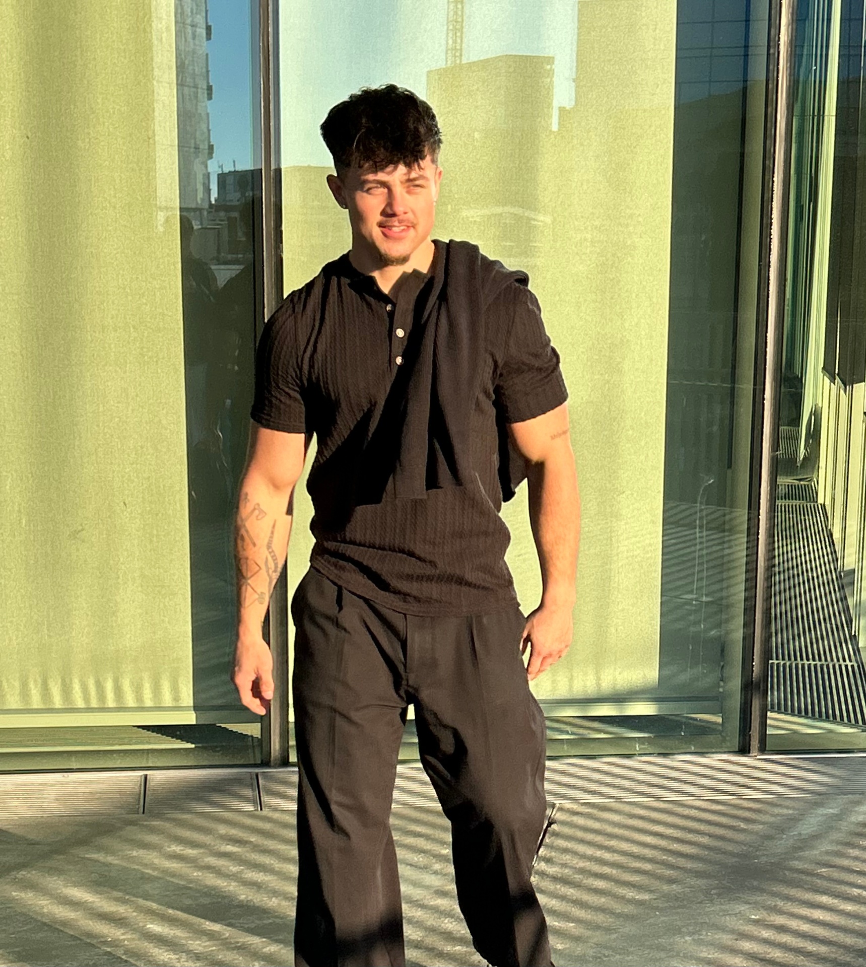 Oliver Borch standing in front of a modern glass building in Copenhagen